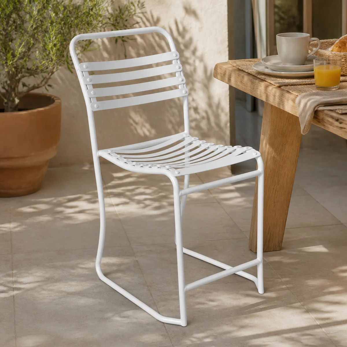 Saltpan Slat Chair staged in a sunny breakfast patio.